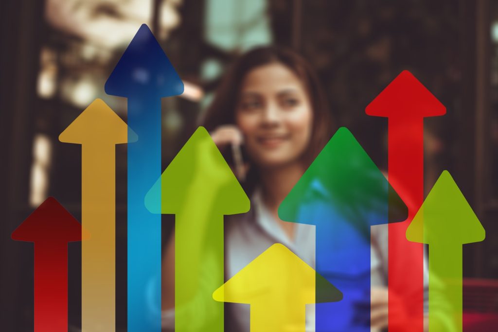 arrows indicating profits increasing with a woman blurred out in the background
