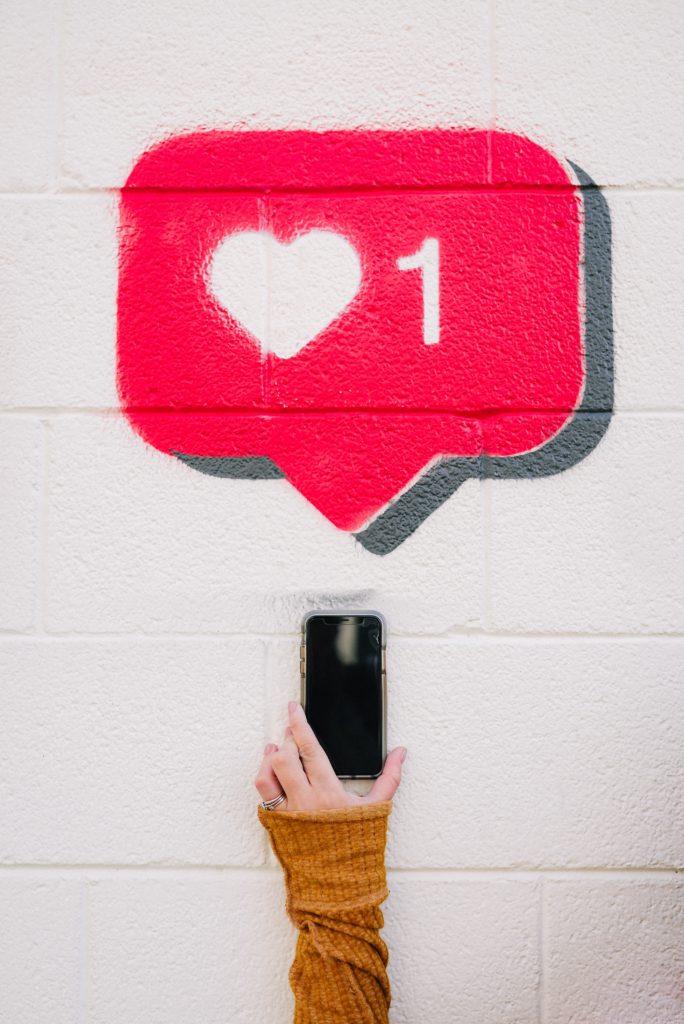 a mobile phone with a love heart in social media post