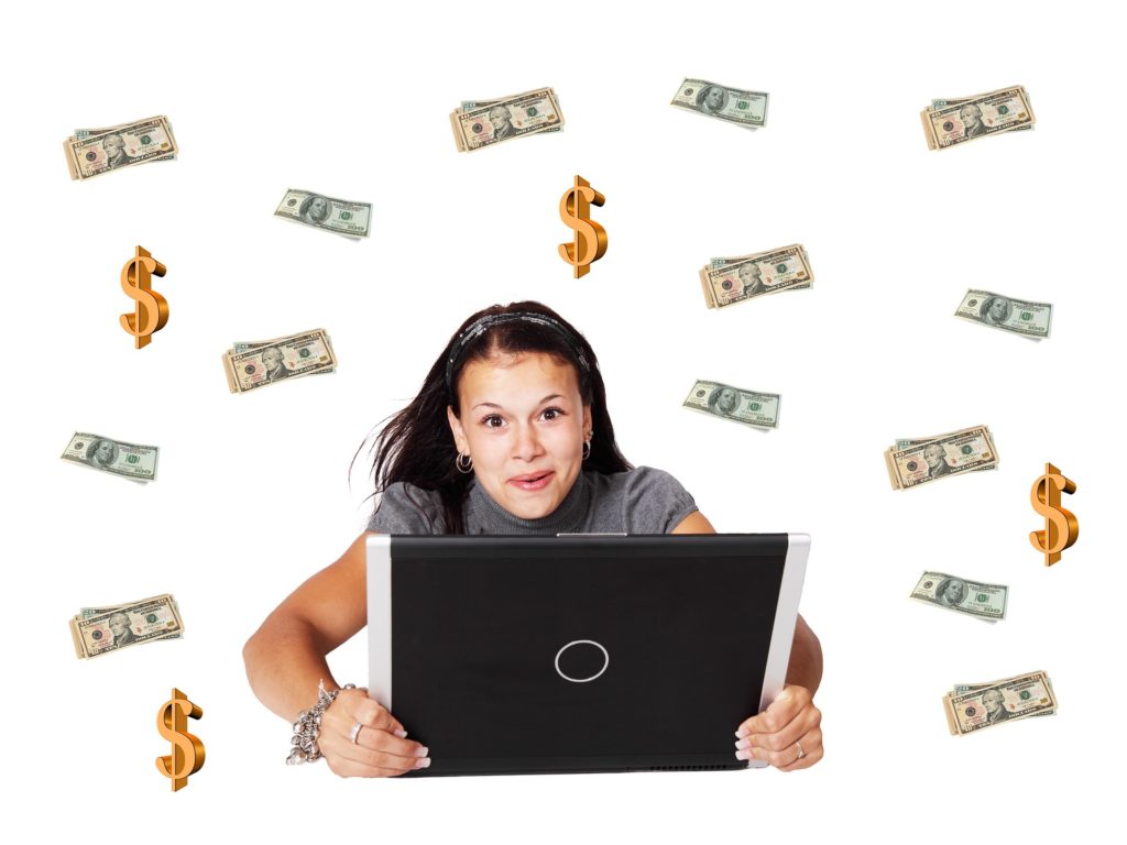 women at her computer with money floating from the sky